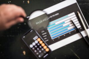 Graph and phone showing tech tools for optimizing coaching practice efficiency